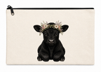 Canvas pouch with a black cow illustration wearing a floral crown on a white background